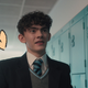 Joe Locke, surrounded with cartoon heart drawings, in a scene from Heartstopper